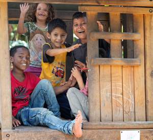 Migrant children play in a treehouse at the Bethlehem Diocesan shelter in Tapachula, Mexico. Photo by Mike DuBose, UM News.