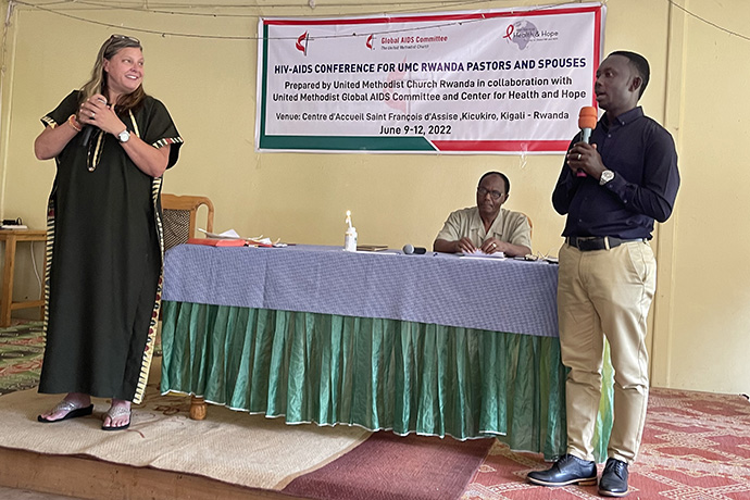 The Rev. Sunny Brown Farley (left) tells how AIDS has affected her life, as the Rev. Marc Baliyanga (center) listens. Farley, who is coordinator of the United Methodist Global AIDS Committee, and Baliyanga, dean of the Rwanda United Methodist Provisional Conference, spoke at a June conference on HIV and AIDS in Kilgali, Rwanda. Photo by the Rev. Donald E. Messer.