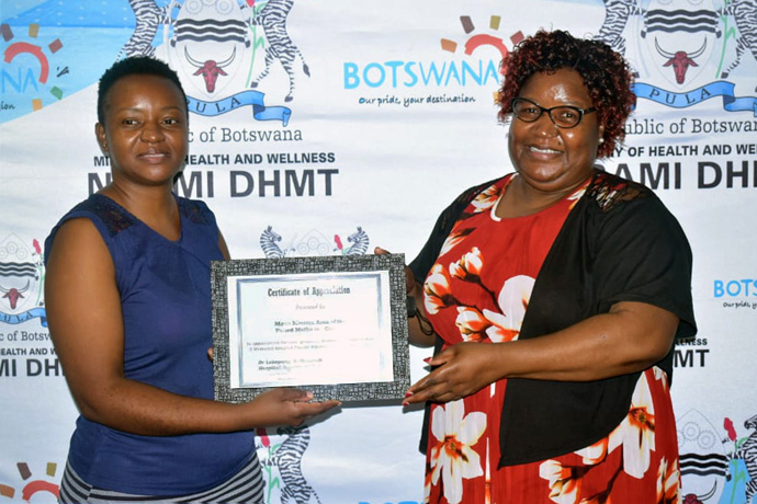 Ratidzai Mukono (left), treasurer of United Methodist Women in Maun, Botswana, and Tsitsi Mabambe, Maun Mission Women chair, receive a certificate of appreciation recognizing the ministry’s contributions. United Methodist Women in Maun celebrated Women’s Month by donating food and toiletries worth $500 U.S. to female patients at Letsholathebe Memorial Hospital, a district facility in Botswana. Photo by Priscilla Muzerengwa, UM News.