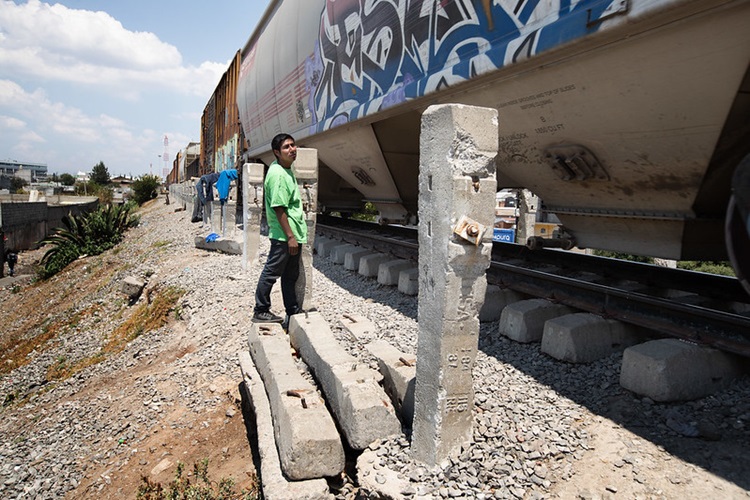 Rubén (izquierda), un migrante de Honduras, conversa con el Rev. Arturo González Sandoval de la Iglesia Metodista de México, al lado de las vías del ferrocarril detrás del refugio Casa de la Sagrada Familia en Apizaco, México. Foto por Mike DuBose, Noticias MU.