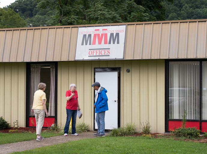 Bishop Leonard Fairley visits with Karen Bunn (center) and the Rev. Karen Stigall at United Methodist Mountain Mission. Bunn is the center’s executive director and Stigall is superintendent of the Kentucky Conference’s South East District, where much of the recent flooding occurred. Photo by Mike DuBose, UM News.