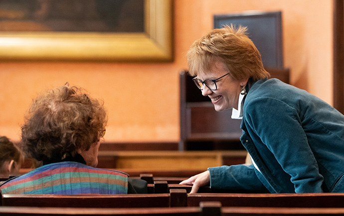 The Rev. Ivana Procházková visits with a parishioner at Prague 2 United Methodist Church. She is superintendent of the United Methodist Church in the Czech Republic. Photo by Mike DuBose, UM News. 