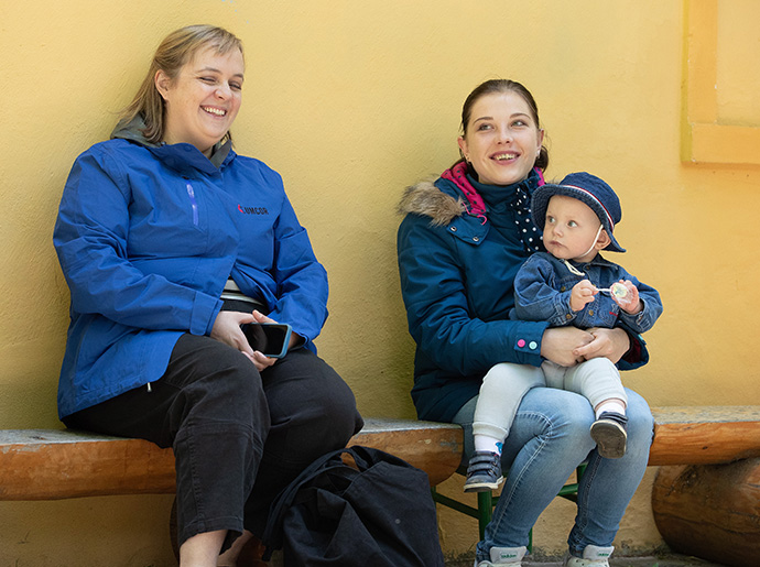 Katie Hills Uzoka (izquierda) del Comité Metodista Unido de Ayuda visita a Vlada y su hijo, Dima, en el campamento de la Iglesia Metodista Unida de Poušť.  La madre y el niño huyeron de su hogar cerca de Mykolaiv, Ucrania, después de que su esposo fuera a la guerra como parte del servicio militar obligatorio de Ucrania.  Uzoka es director de respuesta internacional a desastres de la agencia de ayuda de la denominación.  Foto de Mike DuBose, Noticias UM.