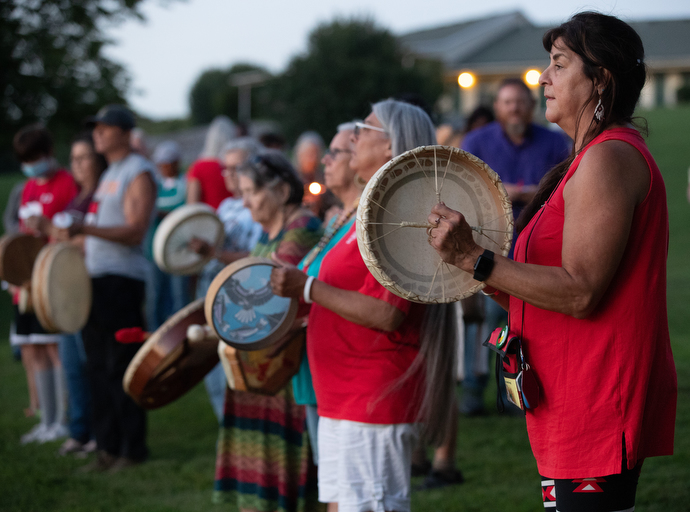 Debbie Fitzhugh (right) joins with other drummers to commemorate missing and murdered indigenous women during Native Moccasins Rock.