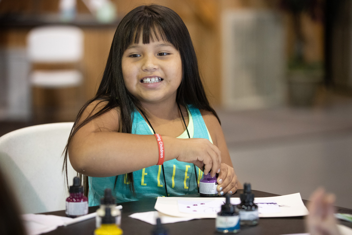 Taloa Thompson, 8, during a workshop on painting by the spirit during Native Moccasins Rock.