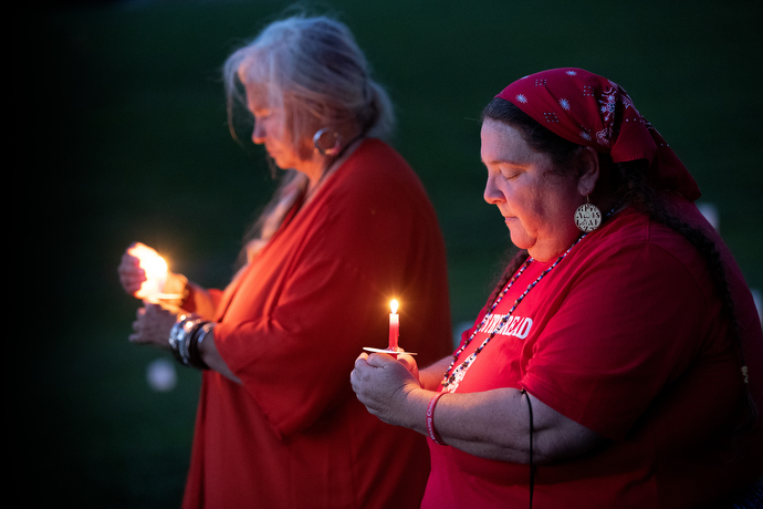 Tonya Dockery (right) and Linda Quick join in a service of remembrance for missing and murdered indigenous women during Native Moccasins Rock