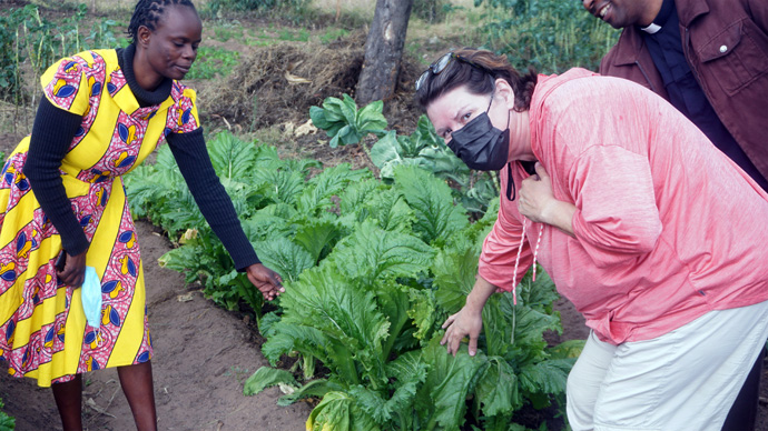 Shamiso Mbwizhu (left), headmistress of Muziti secondary school in the Makoni Buhera District of Zimbabwe, discusses using chicken manure in the vegetable garden with the Rev. Lore Blinn Gibson, Northwest District superintendent. Photo by Kudzai Chingwe, UM News.