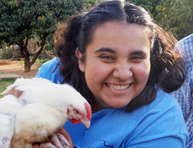 Janée LaFuze, Northwest District lay leader, holds a rooster in the Makoni Buhera District of Zimbabwe. Photo by Kudzai Chingwe, UM News.
