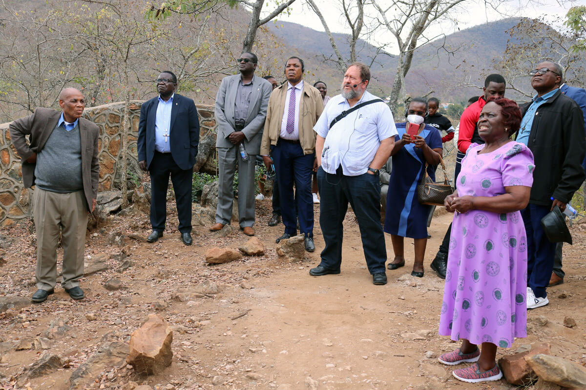 Greater Nhiwatiwa (in purple dress), wife of Bishop Eben K. Nhiwatiwa (left), explains the history and significance of the Chin'ando prayer mountain to bishops attending the Africa College of Bishops retreat held Sept 5-8 at Africa University in Mutare, Zimbabwe. The bishops released a statement at the close of the retreat calling for unity in The United Methodist Church while condemning traditionalist advocacy groups looking to break up the denomination. Photo by Eveline Chikwanah, UM News.