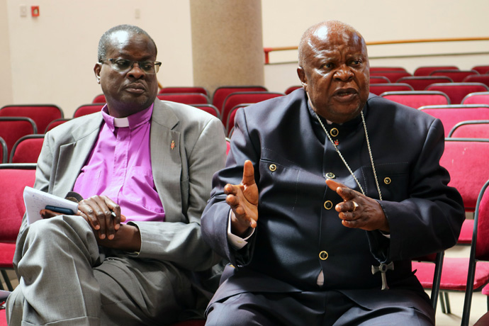 Retired Bishop Ntambo Nkulu Ntanda (right), who led the North Katanga Episcopal Area, contributes during a presentation on worship while Bishop Daniel Wandabula of the East Africa Episcopal Area looks on during the Africa College of Bishops retreat held Sept 5-8 at Africa University in Mutare, Zimbabwe. The bishops released a statement saying they “will not tolerate anyone giving false information about The United Methodist Church.” Photo by Eveline Chikwanah, UM News.