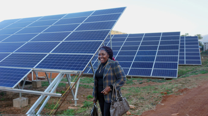 Hospital administrator Monica Nzarayebani stands near the new 120-panel solar system installed as part of an upgrade to the Old Mutare Mission Hospital in Mutare, Zimbabwe. Photo by Kudzai Chingwe, UM News.