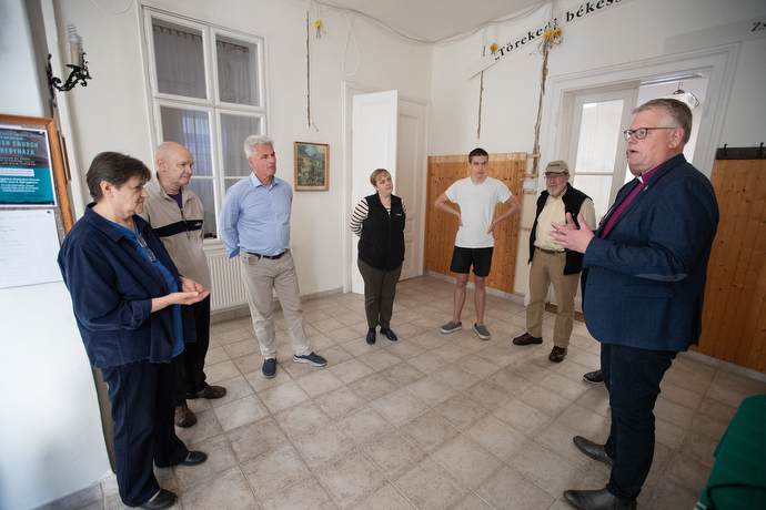 The Rev. Elizabeth Hadju (left) and Bishop Christian Alsted (right) share a time of prayer at Nyíregyháza (Hungary) United Methodist Church before a group, including representatives of the United Methodist Committee on Relief, took relief supplies gathered at the church across the border into Ukraine to help people displaced by the war with Russia. Photo by Mike DuBose, UM News.