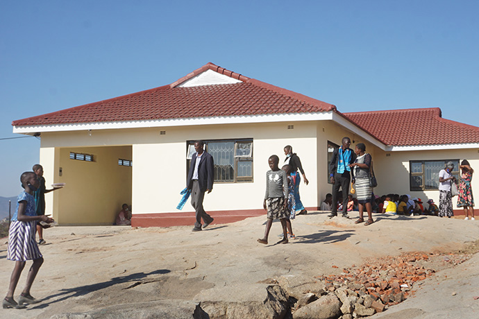 Community members tour the grounds of a new parsonage that was part a gift from a local family to Bwanya United Methodist Church in Mutoko, Zimbabwe. Photo by Kudzai Chingwe, UM News. 