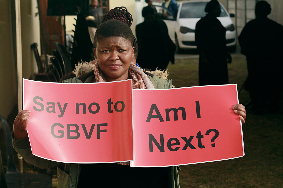 Charlotte Monaheng holds a sign protesting gender-based violence during a march organized by The United Methodist Church in the Gugulethu community in Cape Town, South Africa. Photo by Tapiwa Bopoto, UM News.