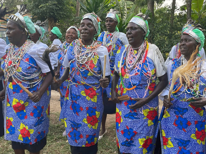 The dedication of a new home for Jackeline and her grandmother, Martha, prompts neighborhood women in Maua, Kenya, to sing and dance, praising donors and God. The home is the first of 12 houses that the Center for Health and Hope and its patrons plan to sponsor this year. Photo by the Rev. Donald E. Messer.