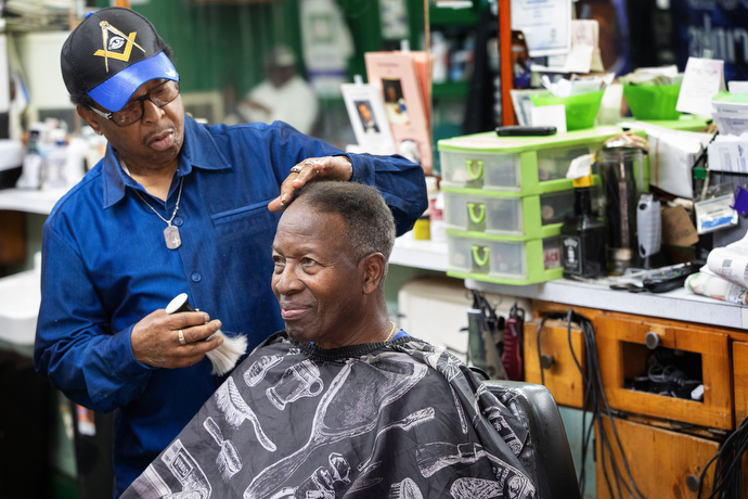 Jake Sherrell puts the finishing touches on a haircut for the Rev. Robert Stout at the Bel-Aire Salon. Stout, the pastor of Berean Baptist Church in Nashville, said Sherrell has been cutting his hair for 30 years. Photo by Mike DuBose, UM News.