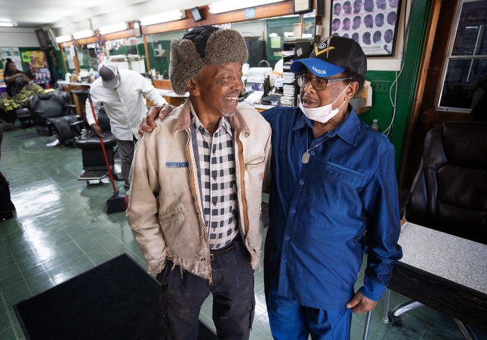 Matthew Jobe (left) visits with Jake Sherrell at Sherrell’s barbershop. The good friends both are longtime members of Gordon Memorial United Methodist Church. Jobe, a certified lay speaker at the church, was the first recipient of an evangelism award created by Gordon Memorial in Sherrell’s honor. Photo by Mike Dubose, UM News.