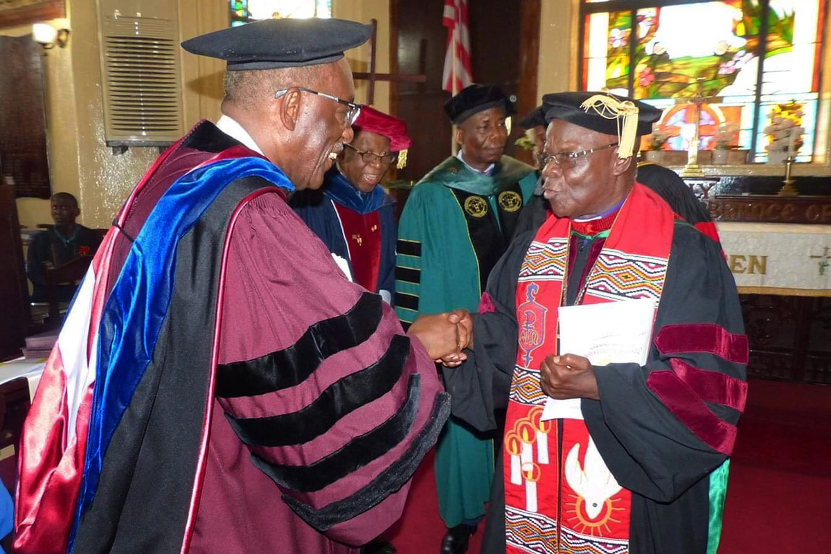 Retired Bishop Arthur F. Kulah (right) shakes hands with Albert B. Coleman, former president of the United Methodist University of Liberia in Monrovia. As United Methodist-related Africa University in Zimbabwe celebrates its 30th anniversary, Liberian church leaders are reflecting on the school’s impact. File photo by E Julu Swen, UM News.