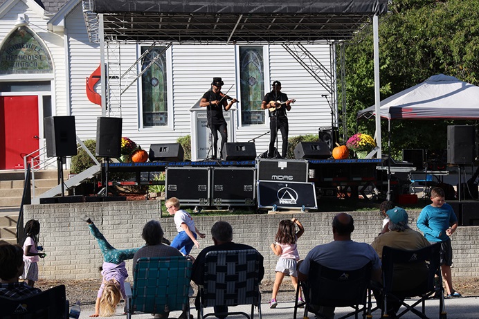 Children dance in front of the stage at Booneville (Iowa) United Methodist Church’s annual music festival. What began as a small way for Booneville United Methodist Church to reach out to the community has blossomed into an annual event attracting hundreds. Photo by Courtney Levin, Iowa Conference.  Children dance in front of the stage at Booneville (Iowa) United Methodist Church’s annual music festival. What began as a small way for Booneville United Methodist Church to reach out to the community has blossomed into an annual event attracting hundreds. Photo by Courtney Levin, Iowa Conference.