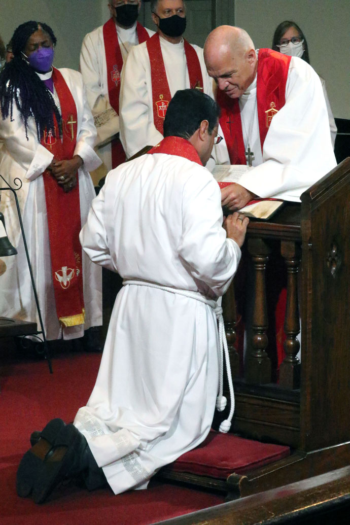 Greater New Jersey Area Bishop John R. Schol presents a bishop’s stole to newly consecrated Bishop Héctor A. Burgos-Núñez during the Northeastern Jurisdictional Conference’s service of consecration at the University of Maryland’s University Chapel in College Park, Md., on Nov. 4. With his election on the third ballot, Burgos-Núñez became the first Hispanic/Latino bishop elected in the jurisdiction. Photo by the Rev. Thomas Kim, UM News.