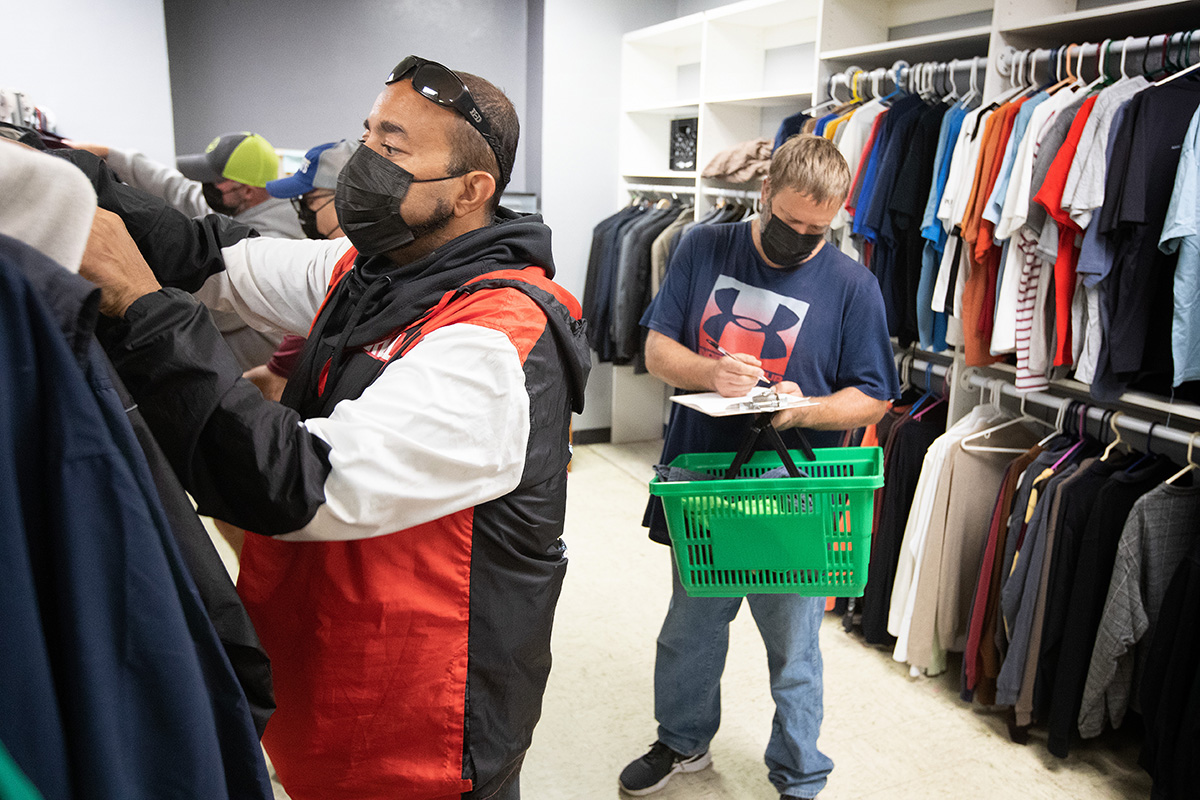 Alex (right) makes a selection from among donated items at the Clothes Closet, a ministry of McKendree United Methodist Church in Nashville, Tenn. Assisting him is church member and volunteer Jeremy Rutan. Photo by Mike DuBose, UM News.