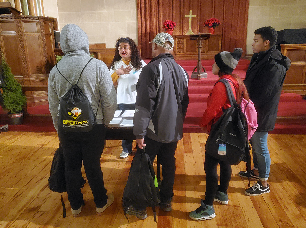 Niurka Meléndez, a founder of Venezuelans and Immigrants Aid, offers practical information and advice to newcomers trying to navigate New York City. The aid group is a partner with the United Methodist Church of St. Paul and St. Andrew in assisting the recent influx of asylum seekers there. Photo by K Karpen.