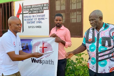 Pastor Kanya Kamahiro Georges (at right) receives his stipend during a presentation ceremony held at the Eastern Congo episcopal office. The assistance from Wespath allows 12 student pastors to buy food and provide for other needs for eight months. Photo by Chadrack Tambwe Londe, UM News. Pastor Kanya Kamahiro Georges (at right) receives his stipend during a presentation ceremony held at the Eastern Congo episcopal office. The assistance from Wespath allows 12 student pastors to buy food and provide for other needs for eight months. Photo by Chadrack Tambwe Londe, UM News.
