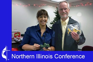 "Kids Above All" Vice President of Resource Development Zulma Colon (left) poses with the late Rev. Doug Williams in 2017. The Rev. Doug Williams, who died in 2019, brought the idea of making and distributing toy wooden cars to his congregation at Aldersgate United Methodist Church in Rockford, Ill., in 2011 as a new ministry to children. Photo courtesy of the Northern Illinois Conference. "Kids Above All" Vice President of Resource Development Zulma Colon (left) poses with the late Rev. Doug Williams in 2017. The Rev. Doug Williams, who died in 2019, brought the idea of making and distributing toy wooden cars to his congregation at Aldersgate United Methodist Church in Rockford, Ill., in 2011 as a new ministry to children. Photo courtesy of the Northern Illinois Conference.