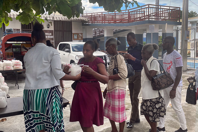 People gather for food distribution at a Port-au-Prince church. Many in Haiti experience food insecurity due to repeated earthquakes, tropical storms and widespread crime. Photo by David Draeger, Methodist Church of Haiti mission volunteer coordinator.