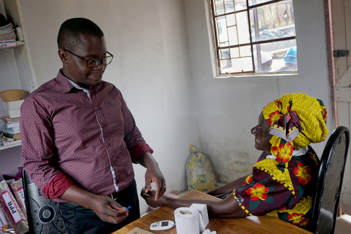 Dr. Walter Mutindori, a United Methodist, attends to a patient during Runyange United Methodist Church’s outreach program in the Makoni Buhera District in rural Zimbabwe. “It gives me self-satisfaction when I help those in need,” he said. Photo by Kudzai Chingwe, UM News.