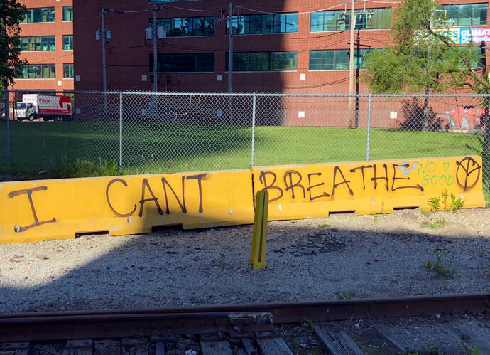 Graffiti in Chicago references the repeated cry of George Floyd when a Minneapolis police officer knelt on his neck on May 25, 2020. The killing of Floyd, a Black man, in that incident is among the subjects touched on in the Rev. William B. Lawrence’s new book “When the Church Woke.” File photo by Ken Erhman, courtesy of the Northern Illinois Conference. 