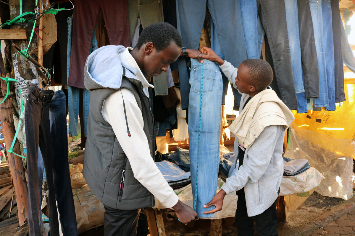 Muriithi Karagara (left) sells clothes at a secondhand clothing store owned by Youth for Christ in Meru, Kenya. The district-wide church youth program is committed to offering alternative livelihoods for those depending on khat production (a naturally growing stimulant) for survival. Photo by Gad Maiga, UM News.
