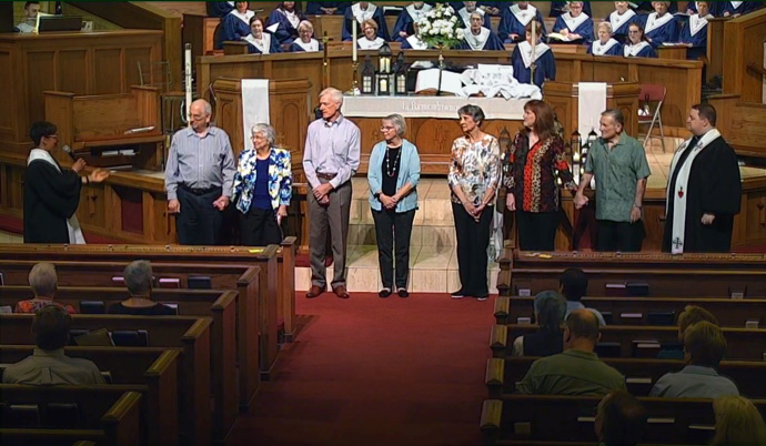 Clear Lake United Methodist Church welcomes new members during a recent service. The Houston church’s pastor, the Rev. Preston Morgan, stands at far right. Clear Lake is among the United Methodist churches adding members and regular visitors as people look for a United Methodist church to be part of after their church disaffiliated. Photo courtesy of Clear Lake United Methodist Church.