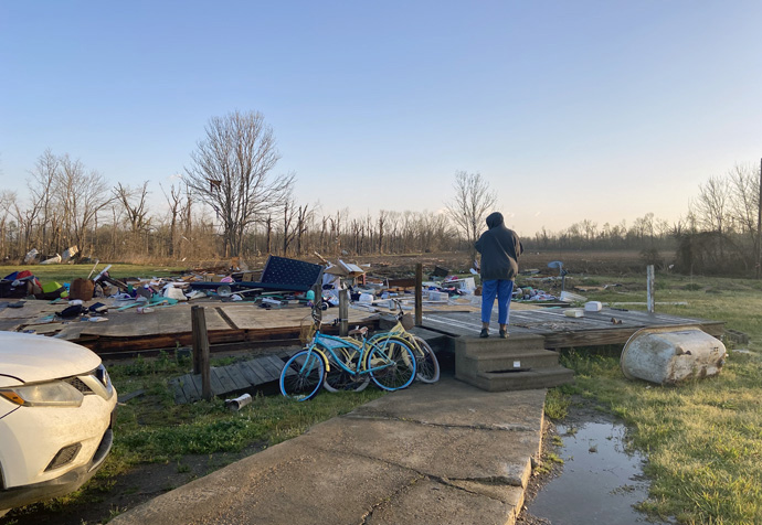 An unidentified person stands on the steps of what used to be a building in Rolling Fork, Miss., on March 25. A line of severe storms nearly obliterated the small town of 2,000 people as it swept across the American South the night before with Mississippi being particularly hard hit. Photo courtesy of the Community Foundation of Northwest Mississippi.