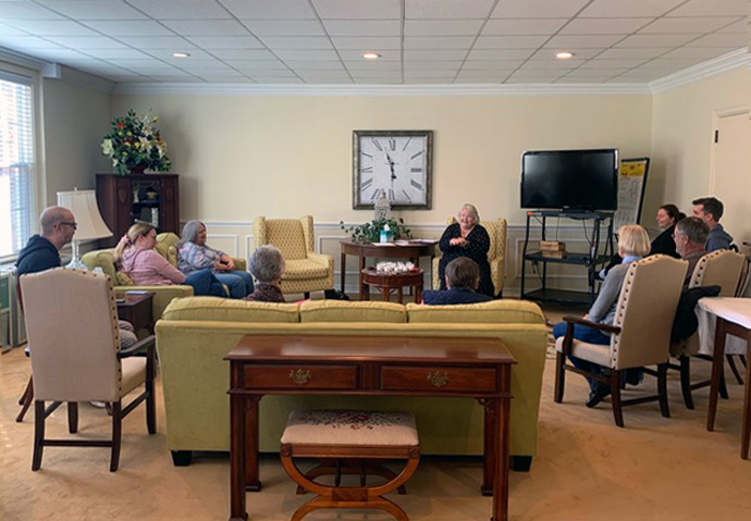 The Rev. Claire Clyburn (seated between clock and TV) leads a small group meeting for people who want to remain United Methodist after their church voted to leave the denomination. Clyburn’s church, First United Methodist Church of Graham, North Carolina, is one of the North Carolina Conference’s Lighthouse Congregations. Photo by Sharon Smith.