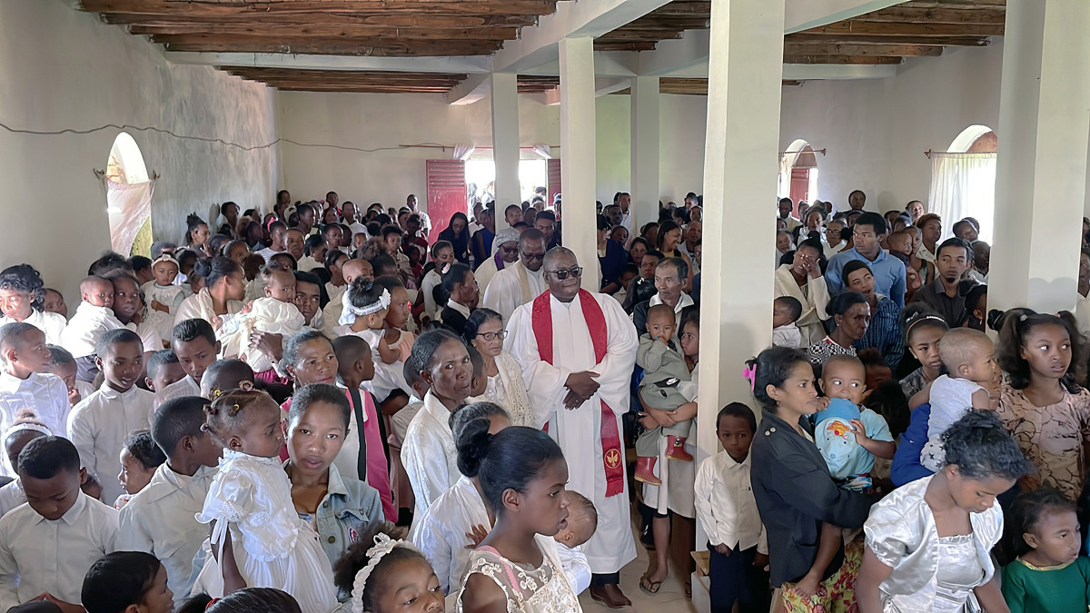 Nearly 500 people gathered on Feb. 27 for the founding service of Ambodifasika United Methodist Church in Madagascar. The Revs. Machegane Face (with red stole) and João Sambô are followed by Bishop Joaquina Nhanala as they lead the processional into the church. Photo by the Rev. Gustavo Vasquez, UM News.