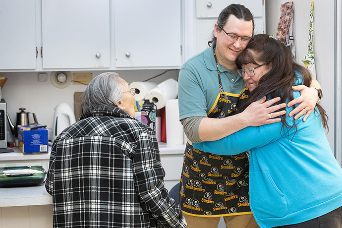 Nina Gorman (right) hugs the Rev. Murray Crookes in the kitchen at Every Nation United Methodist Church in Anchorage, Alaska, where Crookes and his family host a weekly fellowship meal and Bible study. Photo by Mike DuBose, UM News. Nina Gorman (right) hugs the Rev. Murray Crookes in the kitchen at Every Nation United Methodist Church in Anchorage, Alaska, where Crookes and his family host a weekly fellowship meal and Bible study. Photo by Mike DuBose, UM News.