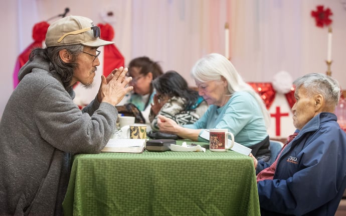 Church and community members read Scripture during the weekly Bible study at Every Nation United Methodist Church. Photo by Mike DuBose, UM News.