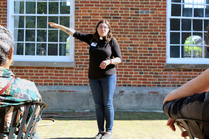 The Rev. Bonnie McCubbin speaks to travelers with the Social Justice Pilgrimage in the courtyard of Old Otterbein United Methodist Church in Baltimore, where she is the pastor. McCubbin organized the May 6 pilgrimage. Photo by Vernon Jordan, UM News.