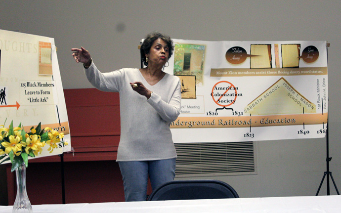 Church leader Dolores Greene speaks to visitors from the Social Justice Pilgrimage in front of a timeline of history at Mt. Zion United Methodist Church, a historic Black church located in the Georgetown neighborhood of Washington. Sixteen pilgrims traversed the nation’s capital and Baltimore on May 6, taking in United Methodist churches, cemeteries and The United Methodist Building near the U.S. Supreme Court. Photo by Vernon Jordan, UM News.