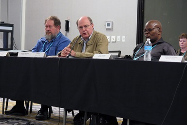 The Rev. Lynn Hill, retired elder in the Tennessee-Western Kentucky Conference, preaches at the closing worship of the Commission on the General Conference meeting in Florence, Kentucky. Hill is the chair of the commission’s program committee. Beside him are Don Reasoner, who leads interpretation at General Conference, and Mills Maliwa, a commission member from South Africa. Photo by Heather Hahn. The Rev. Lynn Hill, retired elder in the Tennessee-Western Kentucky Conference, preaches at the closing worship of the Commission on the General Conference meeting in Florence, Kentucky. Hill is the chair of the commission’s program committee. Beside him are Don Reasoner, who leads interpretation at General Conference, and Mills Maliwa, a commission member from South Africa. Photo by Heather Hahn.