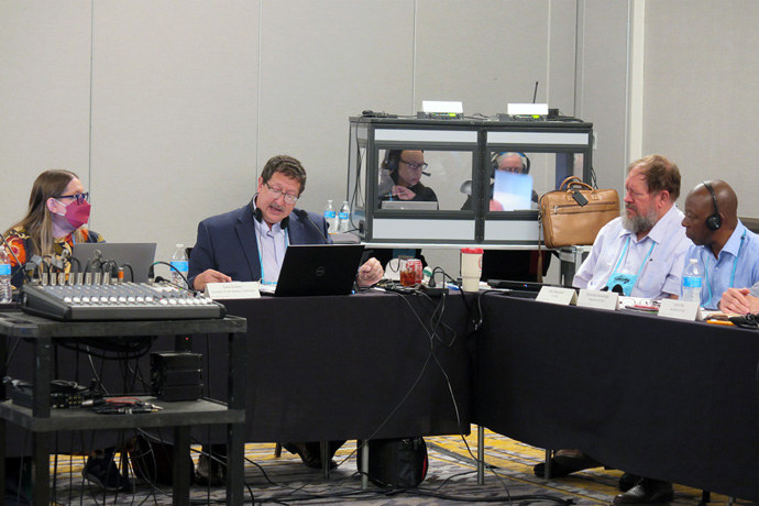The Rev. Gary Graves, secretary of General Conference, describes what has happened over the past years of planning the pandemic-postponed General Conference. At left is Sara Hotchkiss, General Conference business manager. Photo by Heather Hahn, UM News.