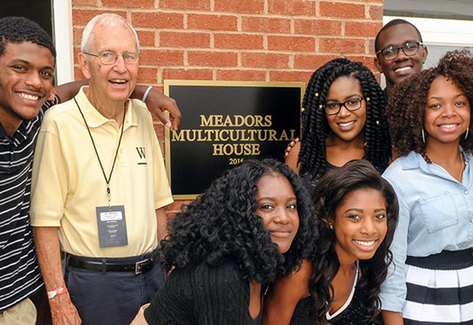 Bishop Marshall L. “Jack” Meadors Jr. poses with students at United Methodist-related Wofford College in 2016. The Meadors Multicultural House, a place on campus that “all students could call home,” was made a reality through the financial support of the Meadors family. Bishop Meadors graduated from Wofford. File photo courtesy of Wofford College.