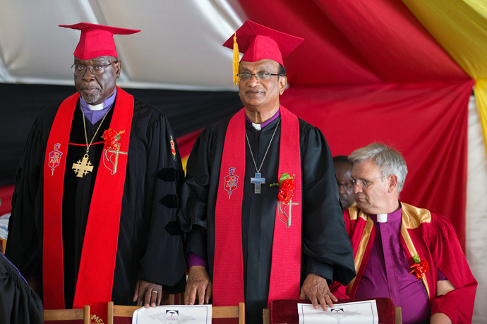 United Methodist Bishops James Swanson (left) and Sudarshana Devadhar are recognized during the 25th anniversary celebration for Africa University in Mutare, Zimbabwe, in 2017. At right is Bishop William T. McAlilly. File photo by Mike DuBose, UM News.