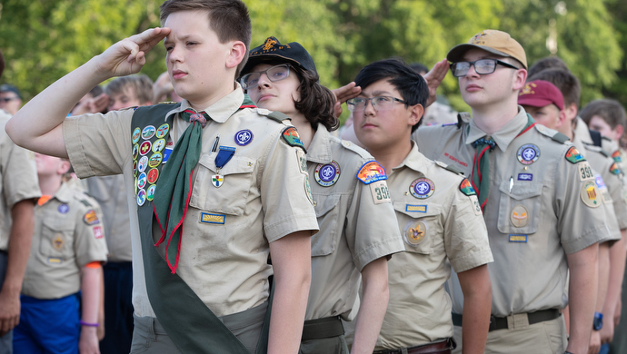 Scouts from Troop 398 salute during the evening flag ceremony at the Boxwell Scout Reservation. Photo by Mike DuBose, UM News.