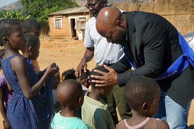 Elison Mukandi (black jacket) and Samuel Muchemwa (striped shirt) lay hands on children wishing to be prayed for at Chipunza Farm in Harare, Zimbabwe, in June. The men’s organization of Chisipiti United Methodist Church launched “Vhuserere,” an evangelism effort to reach people in farming areas. Mukandi is chairperson of the men’s group. Photo by Kudzai Chingwe, UM News. Elison Mukandi (black jacket) and Samuel Muchemwa (striped shirt) lay hands on children wishing to be prayed for at Chipunza Farm in Harare, Zimbabwe, in June. The men’s organization of Chisipiti United Methodist Church launched “Vhuserere,” an evangelism effort to reach people in farming areas. Mukandi is chairperson of the men’s group. Photo by Kudzai Chingwe, UM News.