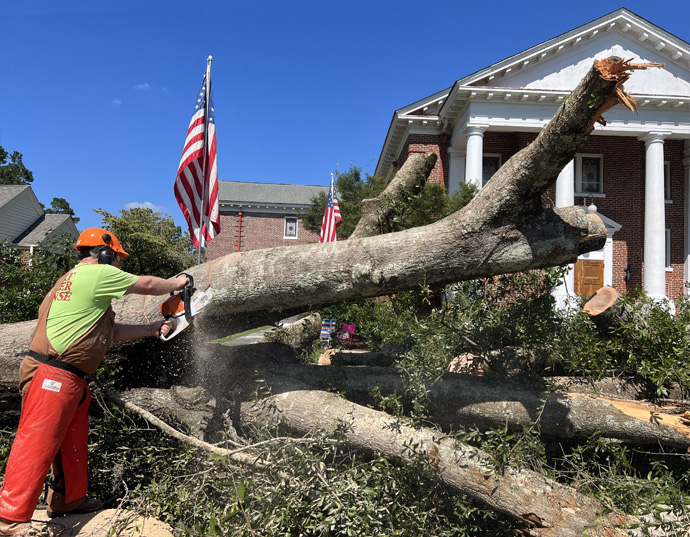 The Rev. John Elmore, pastor of Holly Hill United Methodist Church in Holly Hill, S.C., works with early response team members to chop up a tree that fell outside the church and his parsonage as Idalia blew through the community also bringing flooding in its wake. Elmore is also the leader of an early response team that is part of the South Carolina Conference Disaster Response Ministry. Photo courtesy of the South Carolina Conference.