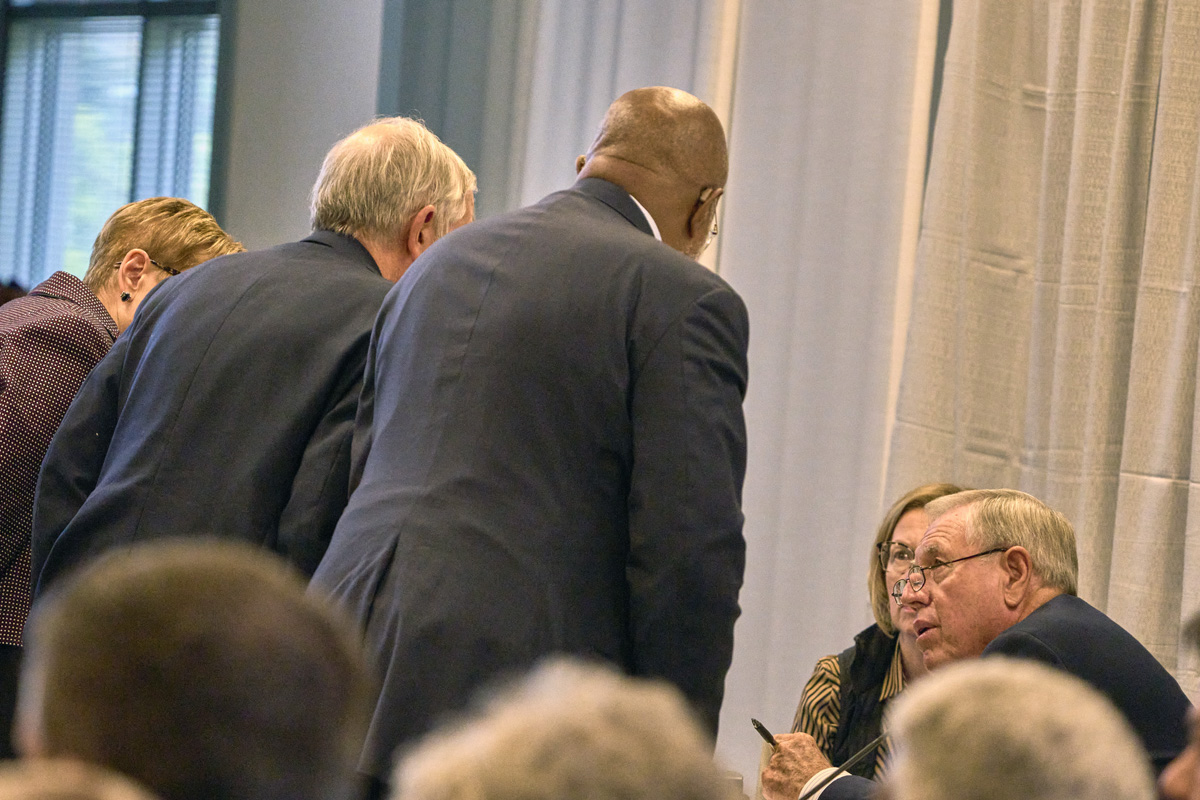 Retired United Methodist Bishop Alfred W. Gwinn speaks quietly with counsel on Sept. 19, the first day of a church trial of Bishop Minerva G. Carcaño in Glenview, Ill. Gwinn is serving as the presiding officer, the equivalent of a judge, in the trial. Carcaño, the suspended bishop of the California-Nevada Conference, is accused of disobedience to the order and discipline of The United Methodist Church, the undermining of another pastor’s ministry, harassment and fiscal malfeasance. Carcaño pleaded not guilty to all four charges. Photo by Paul Jeffrey, UM News.