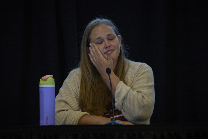 The Rev. Chelsea Constant wipes away a tear as she testifies on Sept. 20, the second day of a church trial of Bishop Minerva G. Carcaño in Glenview, Illinois. Constant is a United Methodist pastor in the California-Nevada Conference and one of several conference members who filed a complaint against Carcaño. Photo by Paul Jeffrey, UM News.