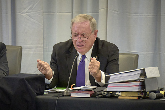 Retired United Methodist Bishop Alfred W. Gwinn leads the trial court in prayer following the reading of a jury verdict finding Bishop Minerva G. Carcaño not guilty of all charges against her. The verdict was announced on Sept. 22, the fourth day of the church trial in Glenview, Ill. Gwinn served as the presiding officer, the equivalent of a judge, in the trial. Photo by Paul Jeffrey, UM News.